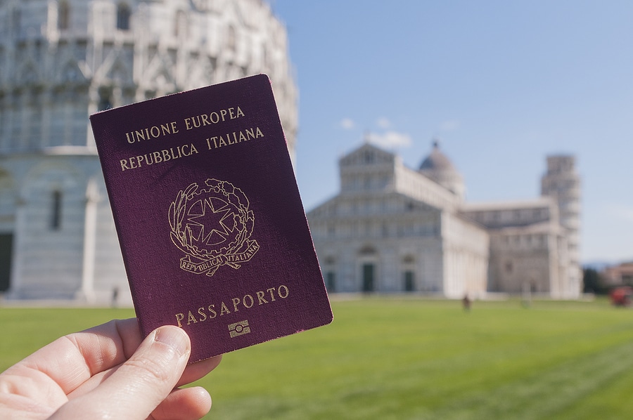 Man Holding An Italian Passport In Front Of The Leaning Tower